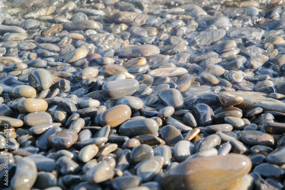 Wet stones on the sea shore Wet stones on the sea shore