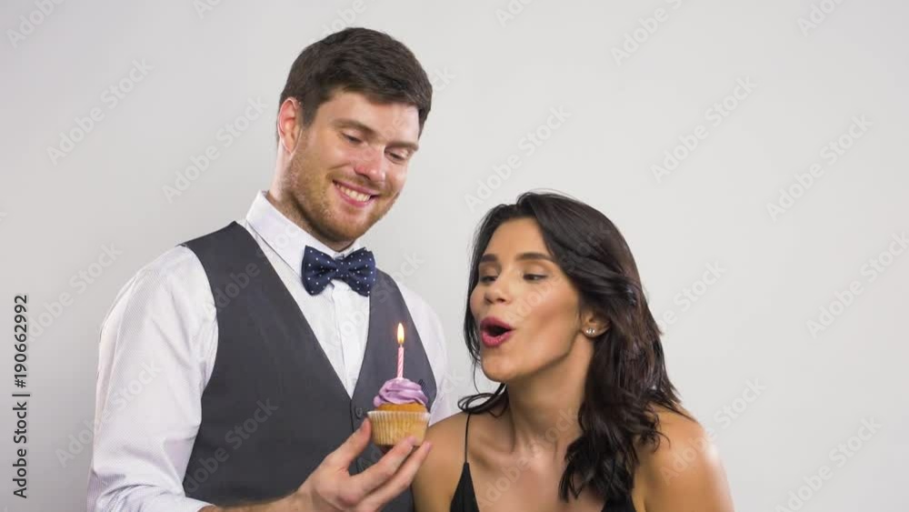 happy couple with birthday cupcake happy couple with birthday cupcake