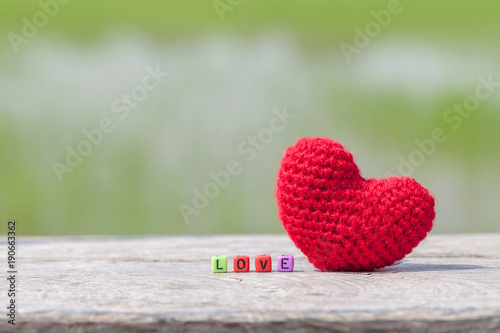 Wooden text block with red heart  for love and valentine day concept.