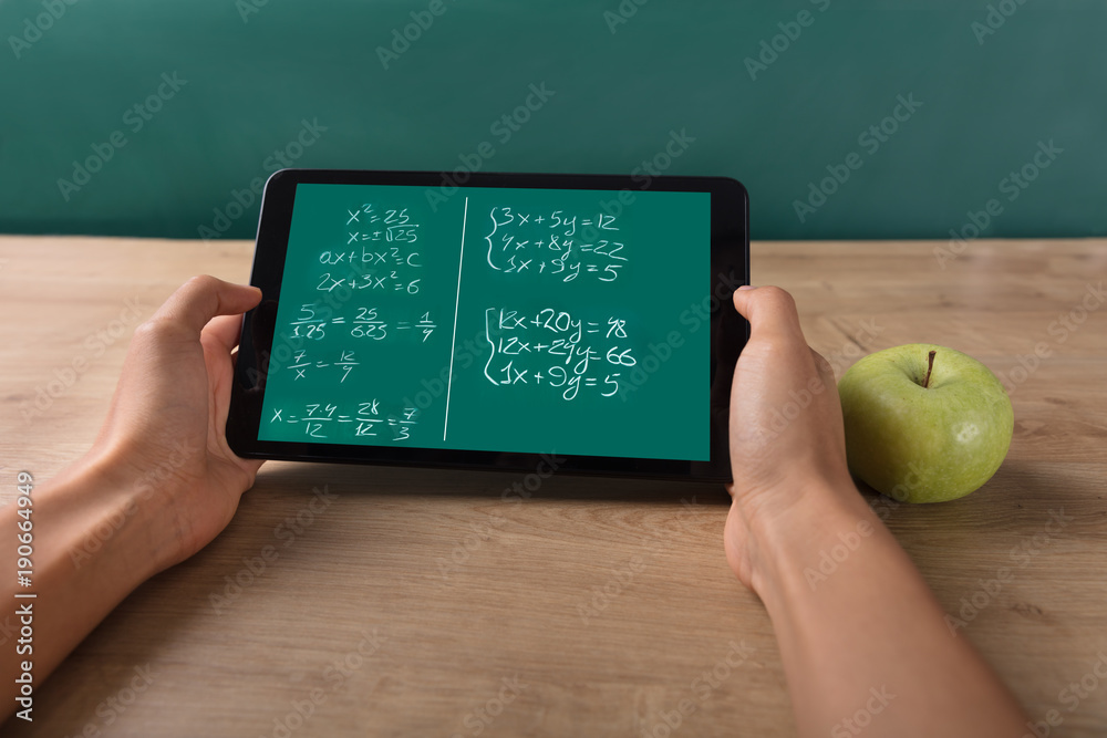 Student Solving Math Problem On Digital Tablet