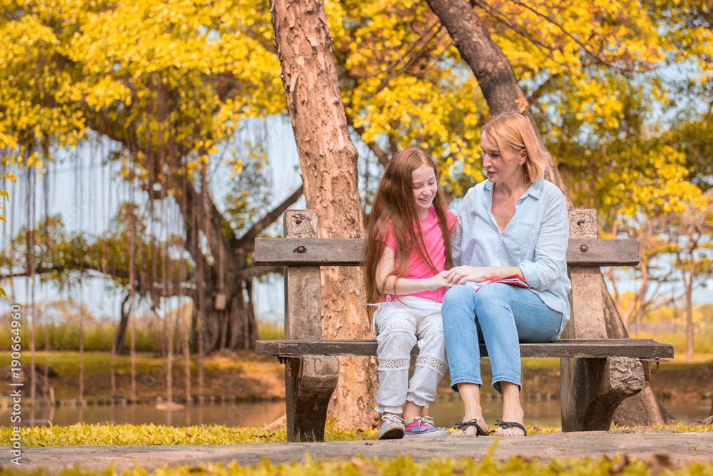 Mom and daughter are sitting in the park. Soft focus concept. Mom and daughter are sitting in the park. Soft focus concept.