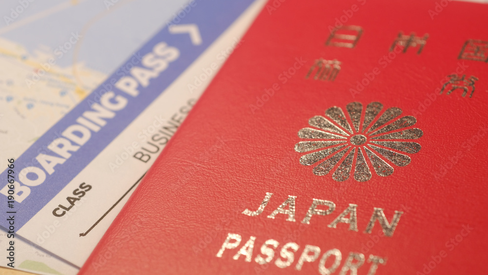 Japanese citizen passport and a flight ticket for a travel Japanese citizen passport and a flight ticket for a travel