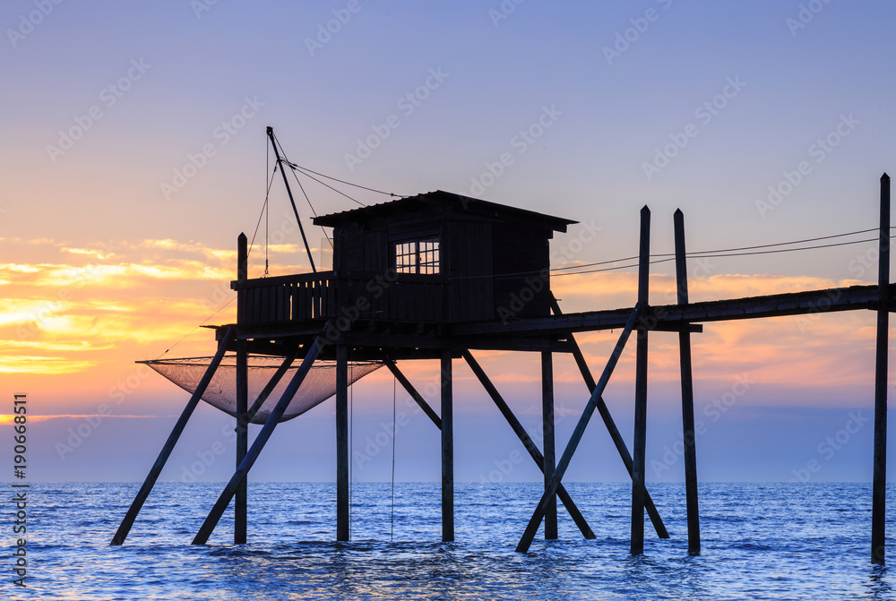 Beautiful view of fishing huts at sunset over the Atlantic Ocean