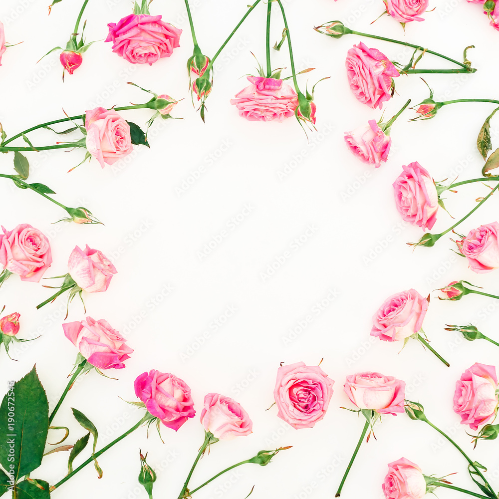 Floral frame with pink roses, buds and leaves on white background. Valentines day. Flat lay, Top view.