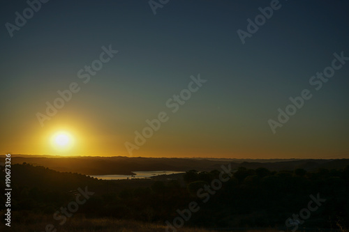 Sunset with a gradient in the sky and a lake