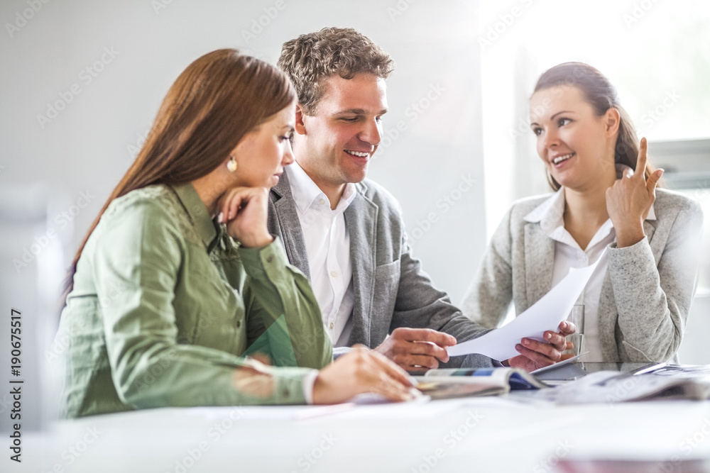 Business people analyzing document in office Business people analyzing document in office