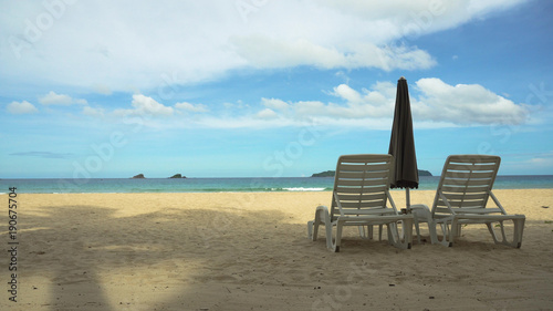 Beach with deck chairs  sun beds  umbrellas. Beach  sea  sand wave. Seascape ocean and beautiful beach paradise  blue sky  clouds. Philippines El Nido Travel concept