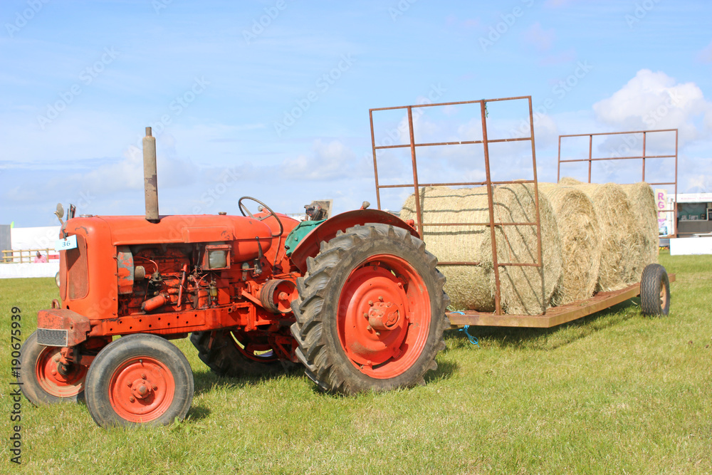 Obraz premium vintage tractor with hay bales