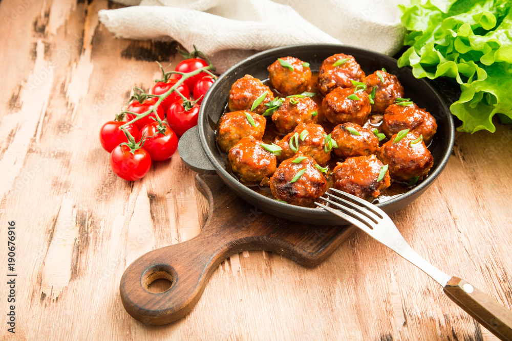 Meatballs in sweet and sour tomato sauce. Homemade roasted beef