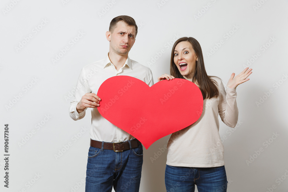 Couple in love. Man and woman with big red heart isolated on white background. Copy space for advertisement. With place for text. St. Valentine's Day International Women's Day birthday holiday concept Couple in love. Man and woman with big red heart isolated on white background. Copy space for advertisement. With place for text. St. Valentine's Day International Women's Day birthday holiday concept