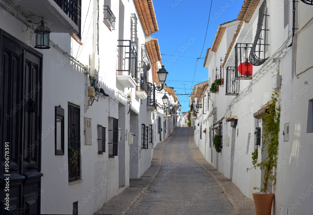 The old center of Altea in Spain. The town of Altea is built on a hill with winding streets and whitewashed houses.