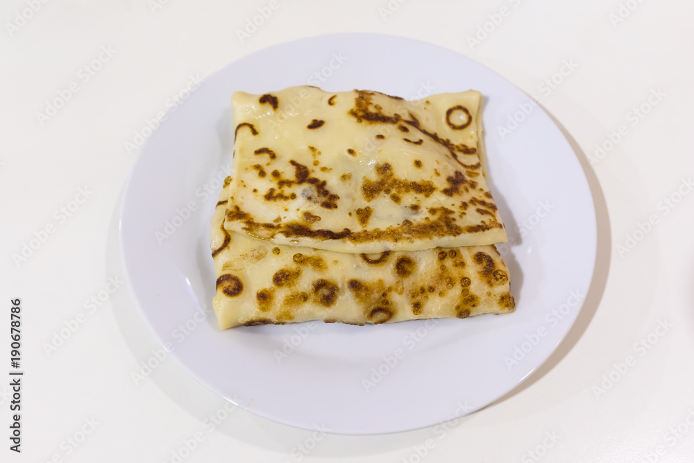 Russian pancake on a white plate