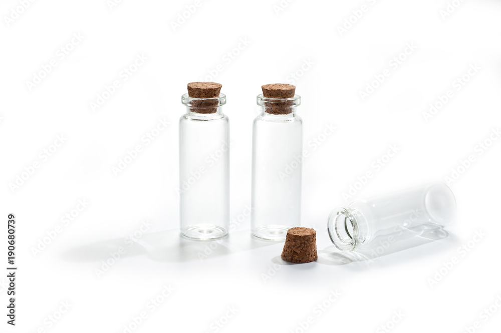 .Small glass bottles with cork lid on white background .Small glass bottles with cork lid on white background
