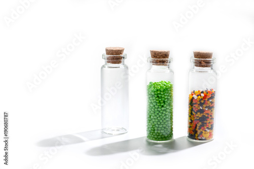 .Powder for Easter cake in glass bottles with cork cover on white background