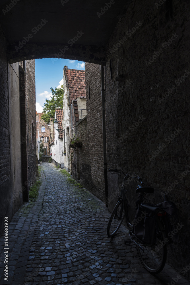 Narrow street with old houses in Bruges, Belgium Narrow street with old houses in Bruges, Belgium
