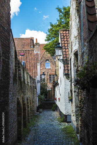 Narrow street with old houses in Bruges, Belgium