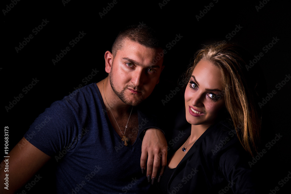 The guy and the girl pose in the studio The guy and the girl pose in the studio