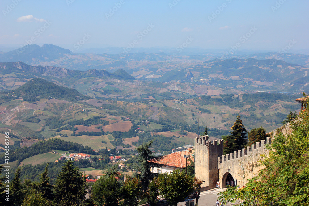 beautiful picturesque panoramic views of San Marino hills and old medieval stone castle wall with battlements