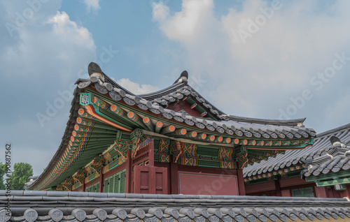 Colorful architecture, wooden roof and tile details, and modeled blue sky, at Gyeongbokgung Palace, Seoul, South Korea