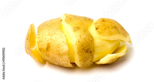 Peeled potatoes on a white background. Raw peeled potatoes and peelings close-up.
