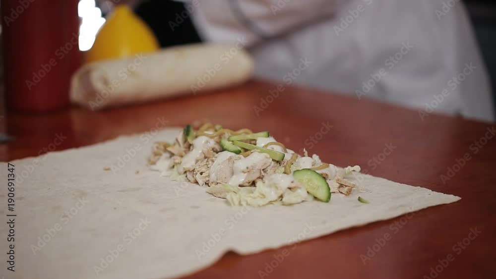 Woman cook in a roadside restaurant prepares Shawarma Woman cook in a roadside restaurant prepares Shawarma