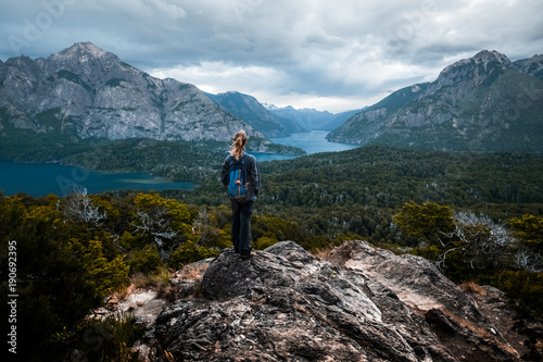 Woman hiker stands and enjoys valley view from the viewpoint. Patagonia, Argentina © Dudarev Mikhail