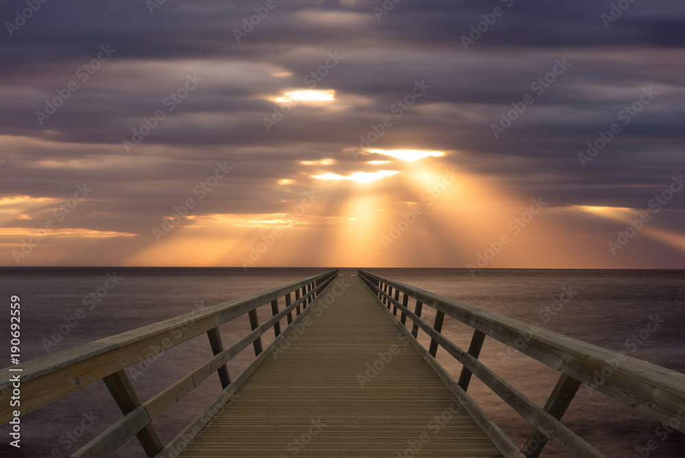 A wooden footbridge that goes into the sea