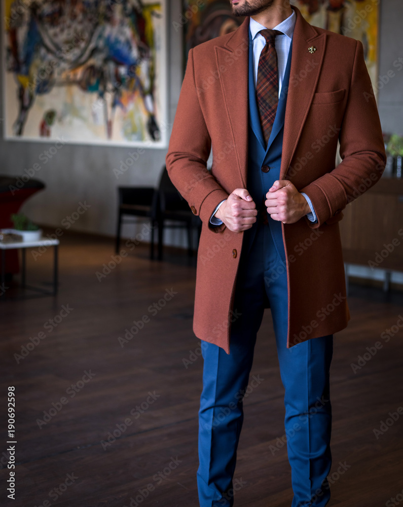 Male model in custom tailored trench coat and suit posing indoors Stock  Photo | Adobe Stock