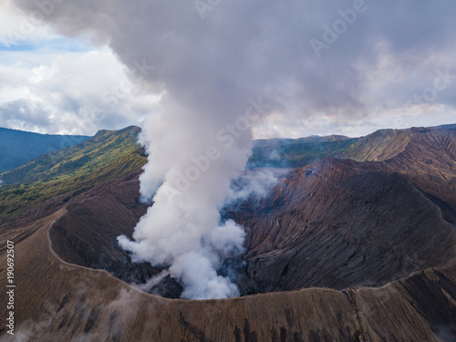 Aerial view to Bromo crater with active volcano smoke in in Bromo Tengger Semeru National Park, East Java, Indonesia.