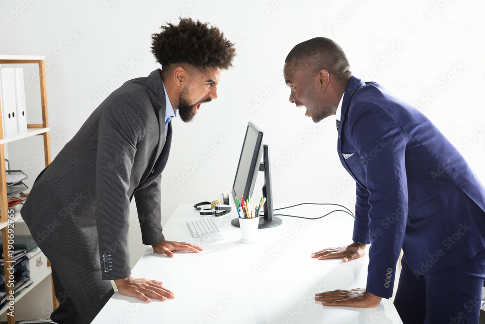 Two Businessmen Shouting At Each Other Two Businessmen Shouting At Each Other