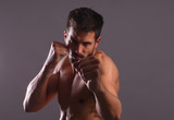 Shirtless male fighter in fighting stance