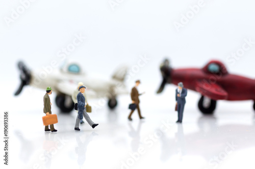 Miniature people : businesses team waiting for airplane travel around the world, business trip travel advisory agency or online world wide marketing concept.