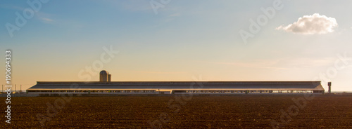 Cowsheds, farm and silo with a field in the foreground. Southern Russia. The Volga-Don