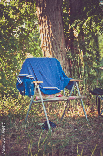 garden chair in green nature on a campsite in summer vacation