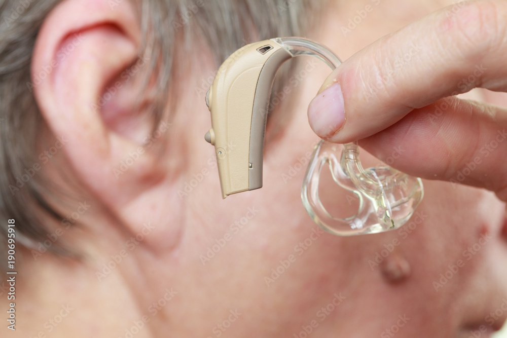 Fototapeta premium Closeup senior woman using hearing aid