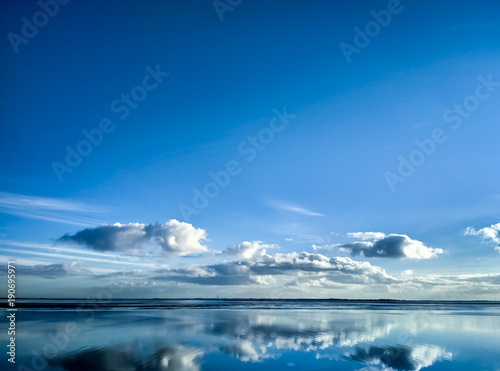 Reflections in the water on a sunny day at Wilhelmshaven Beach, Suedstrand