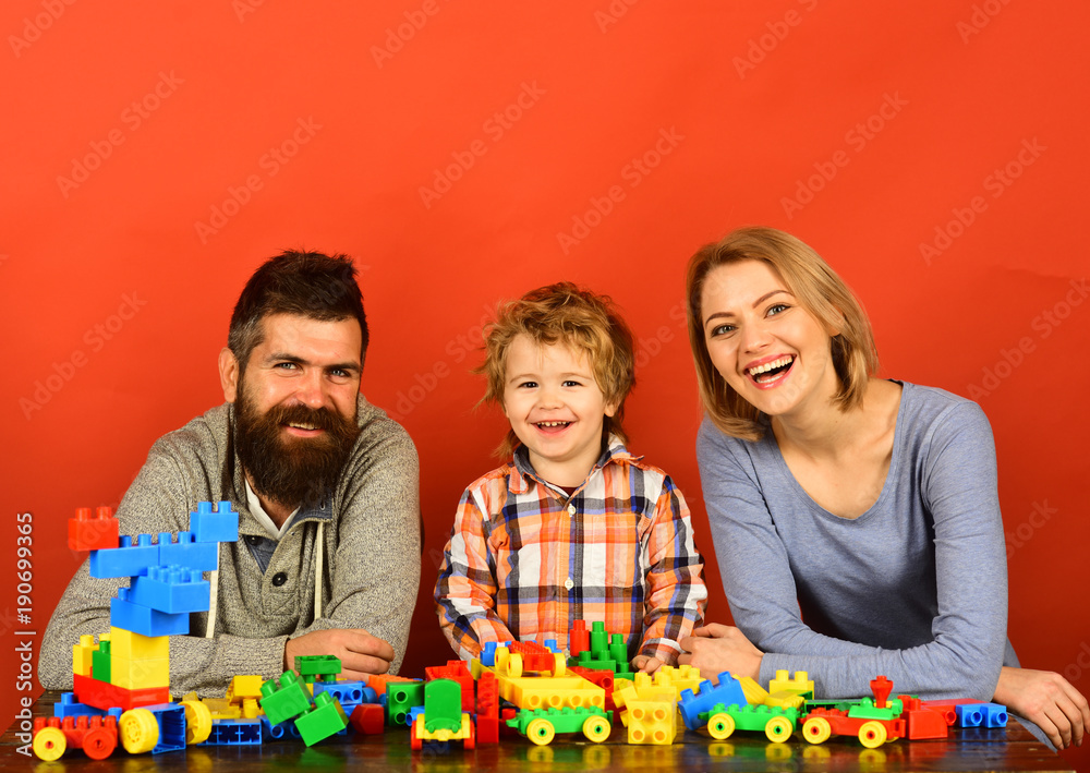 Family with cheerful faces build out of colored construction blocks Family with cheerful faces build out of colored construction blocks