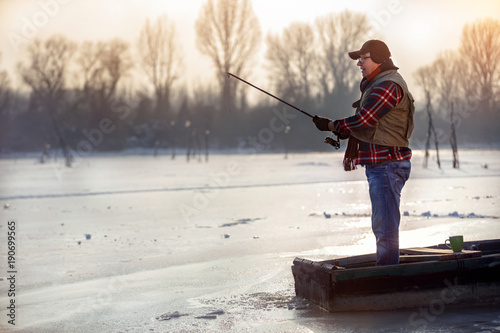 elderly man fishing in the winter