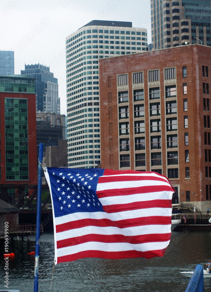 The American Flag sailing through Boston Harbor in the Seaport District