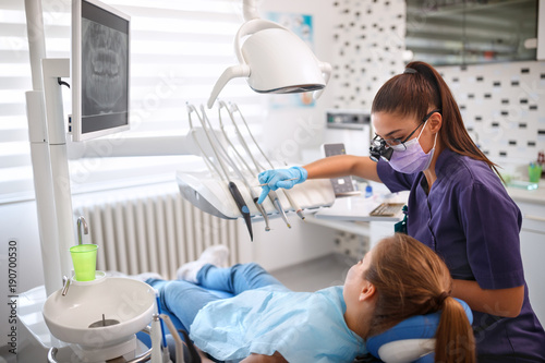 Female dentist working in dental clinic with patient