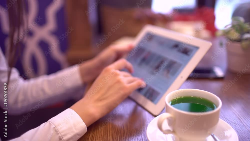Young woman shopping online. Girl using tablet computer indoors. Close-up online clothing store. Woman using tablet computer online shopping stylish clothes working from home, shopping credit cart 4 k Young woman shopping online. Girl using tablet computer indoors. Close-up online clothing store. Woman using tablet computer online shopping stylish clothes working from home, shopping credit cart 4 k