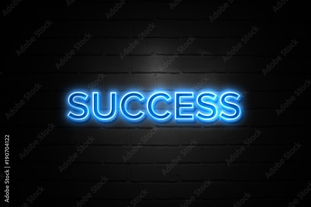 Success neon Sign on brickwall
