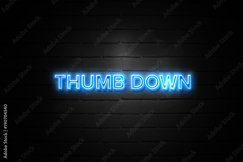 Thumb Down neon Sign on brickwall Thumb Down neon Sign on brickwall