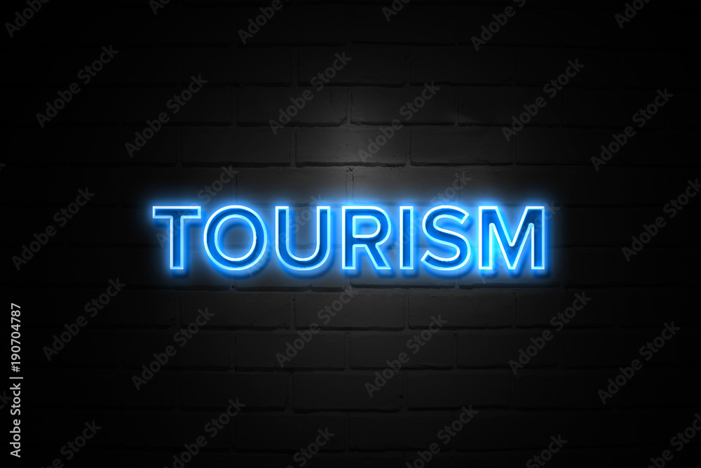 Tourism neon Sign on brickwall Tourism neon Sign on brickwall