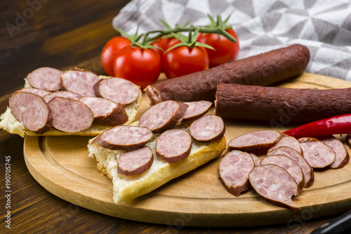 Sandwiches with homemade smoked sausage located on a board - food for consolation - tasty and healthy