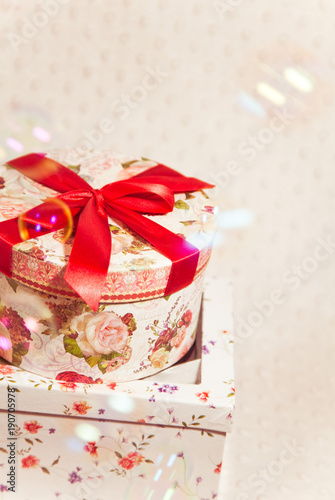 round and square gift boxes with bubbles on plush background photo