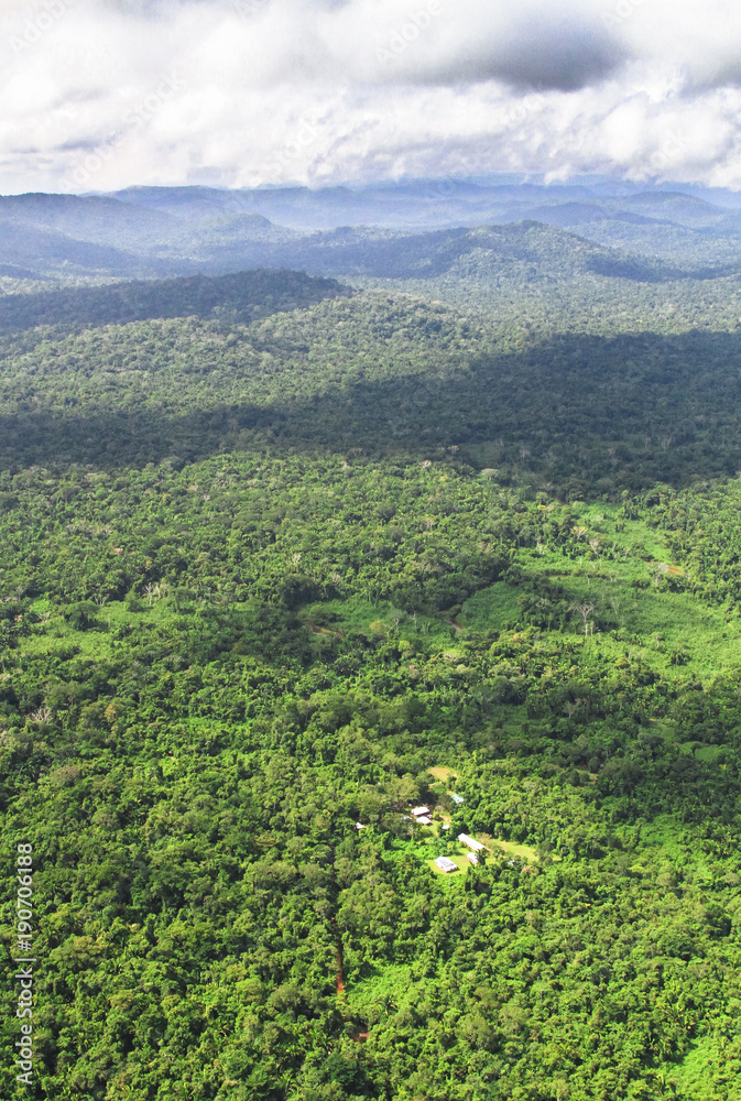 An aerial view of the Cockscomb Basin in central Belize, and some very remote houses nestled in the jungle. An aerial view of the Cockscomb Basin in central Belize, and some very remote houses nestled in the jungle.