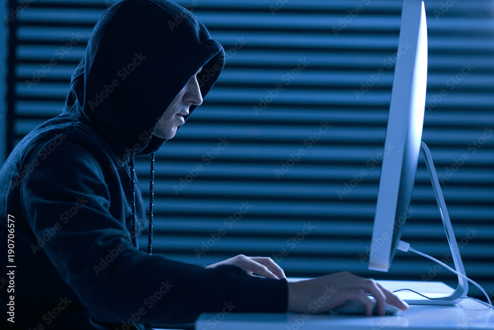 Modern computer. Serious cool male gamer sitting in profile while playing computer game and moving mouse Stock Photo | Adobe Stock Modern computer. Serious cool male gamer sitting in profile while playing computer game and moving mouse Stock Photo | Adobe Stock