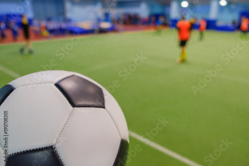 Soccer Ball on Stadium and football players defocused in field © bravissimos