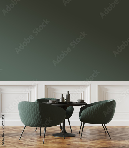 Black round table in a green and white cafe